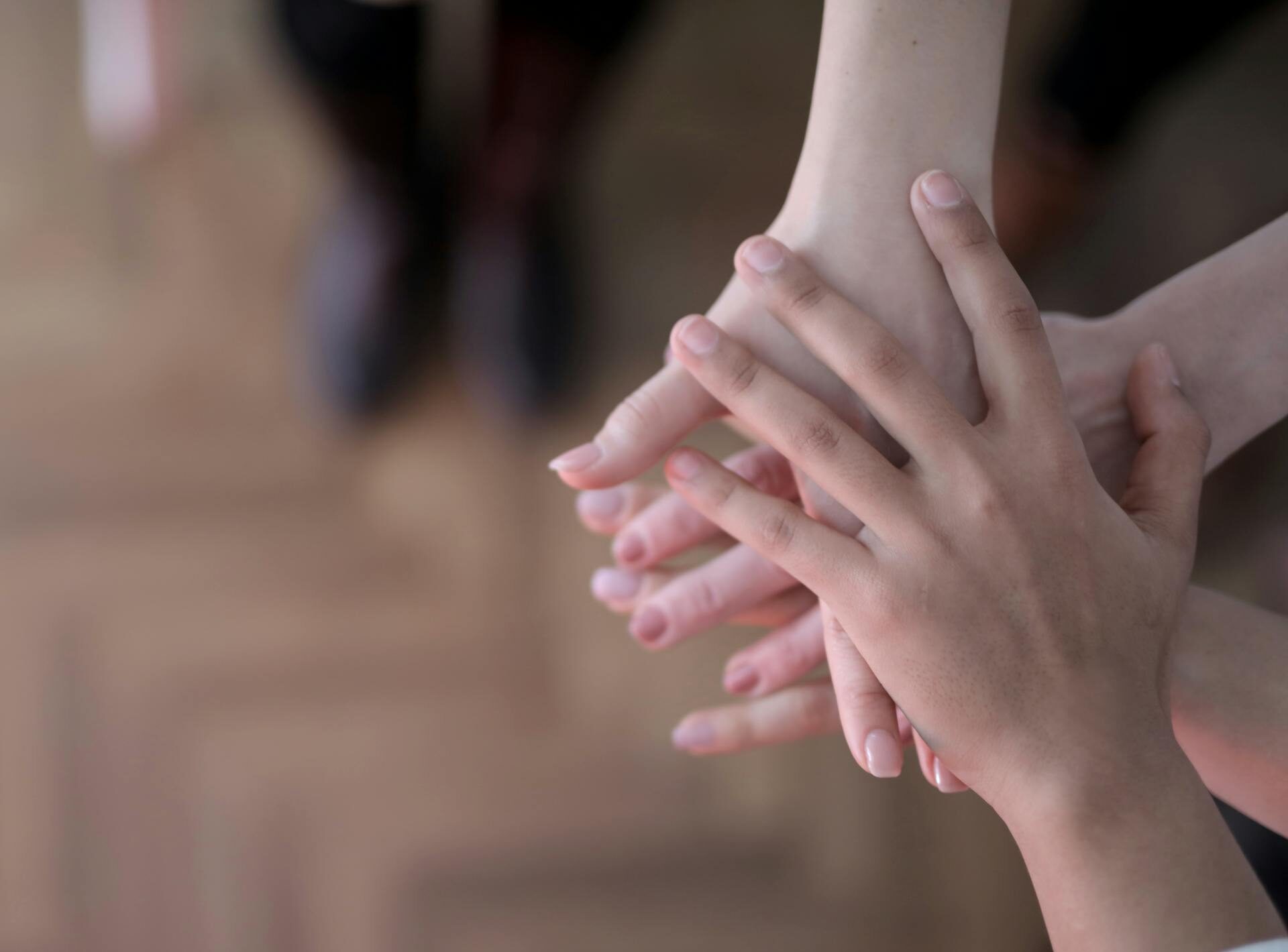 Crop group stacking hands together